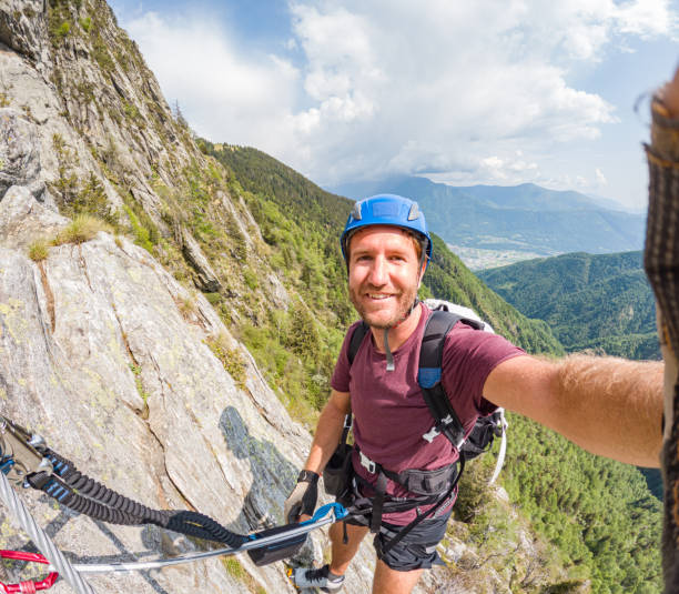 istock Rock climber takes cool selfie on mountain route 1494770321