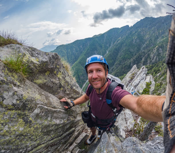 istock Rock climber takes cool selfie on mountain route 1494770404