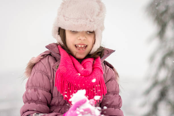 istock Girl playing whit snow during winter day 1494770744