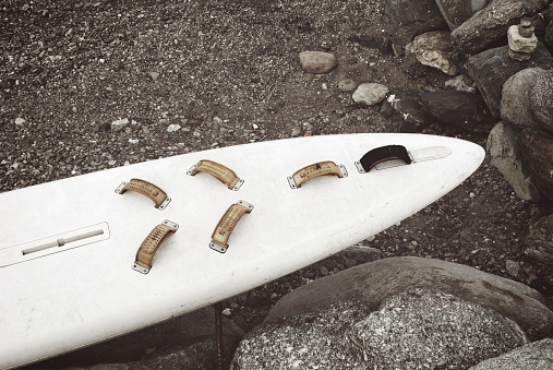a wrecked surfboard on shore