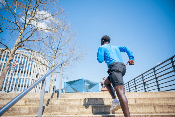 istock young black sportsman running up steps outdoors in modern berlin 1494773082