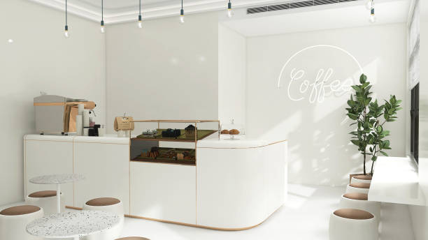 istock Small modern Korean style design cafe, glossy ivory white counter, cake display, professional espresso machine, bar table, stool chair with brown cushion, Indian rubber tree in sunlight from window blinds 1494775349