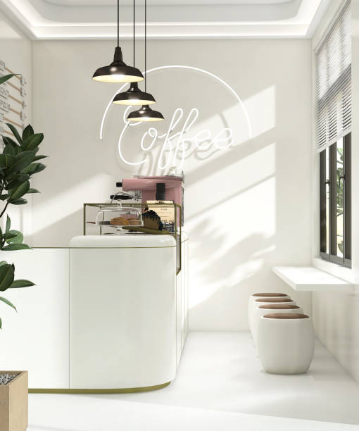 istock Small modern Korean style design cafe, glossy ivory white counter, cake display, professional espresso machine, bar table, stool chair with brown cushion in sunlight from window blinds 1494775378