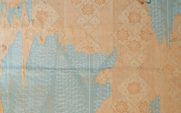 istock Old wallpaper on the wall. Old torn wallpaper for texture or background. 1494775591