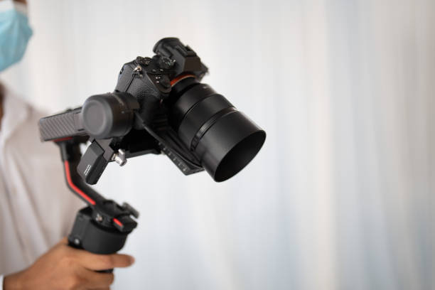 istock Photographer's hand holding a wedding video camera 1494776613