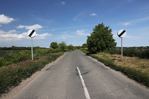 view along straight country road\n\nLong Lane, Lessingham, Norfolk, UK            May
