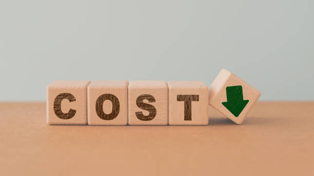 istock COST word on wooden cube block with green down arrow including copy space 1494778998