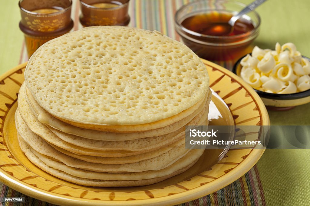 Heap of Moroccan beghrir pancakes Heap of Moroccan beghrir pancakes served with honey and butter Moroccan Culture Stock Photo