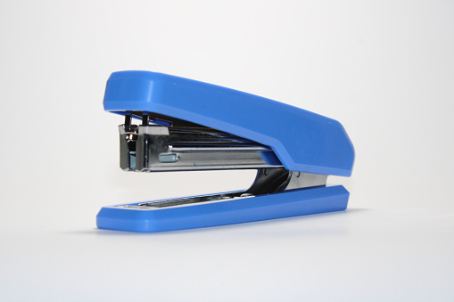 A blue stapler isolated on white background. Clipping path