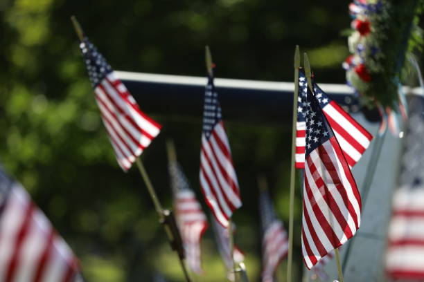 istock American Flags Flying on Veterans Cemetery 1494782690
