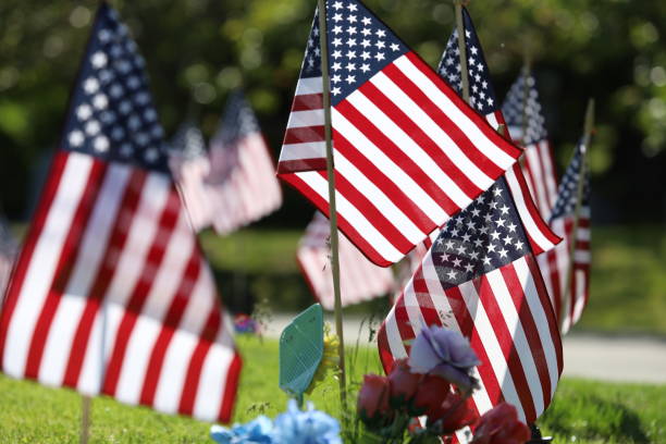 istock American Flags Flying on Veterans Cemetery 1494782764