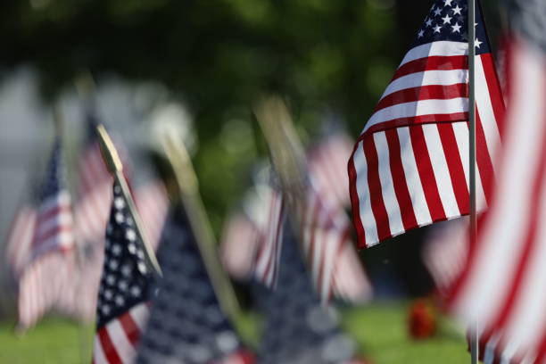 istock American Flags Flying on Veterans Cemetery 1494782799