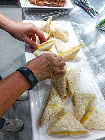 A pastry chef is preparing for the sandwich