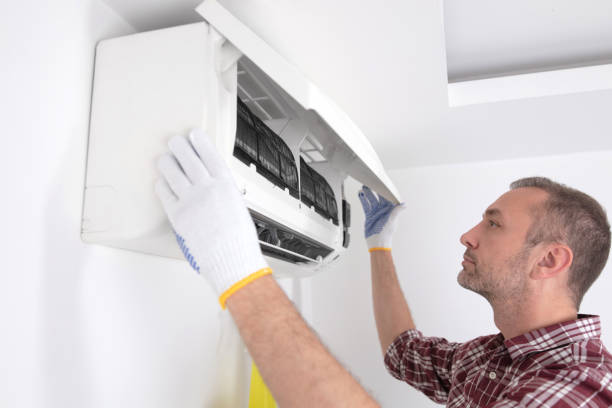 istock Service guy cleaning and maintaining air condition unit. 1494784233