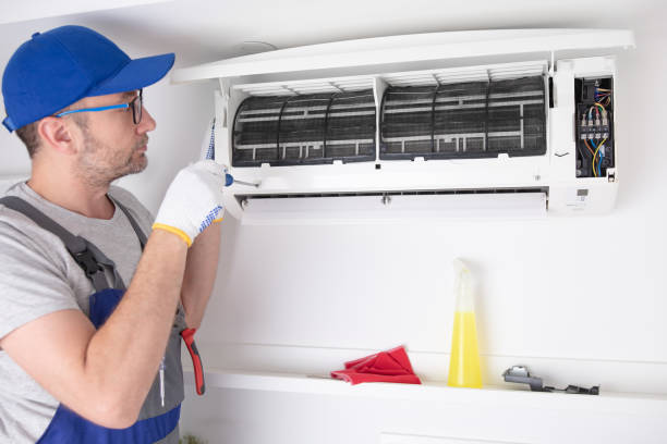 istock Service guy cleaning and maintaining air condition unit. 1494785438