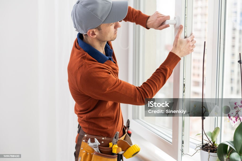 Worker Installing Window Insert Construction Worker Installing Window In House Stock Photo - Download ...