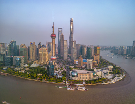 Shanghai, China- April 20, 2023: The drone aerial view of Lujiazui financial and trade zone at dusk, Pudong, Shanghai, China. Lujiazui is the largest financial zone in mainland China.