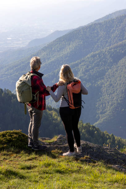 istock Mature couple explore mountain meadow in morning light 1494789294