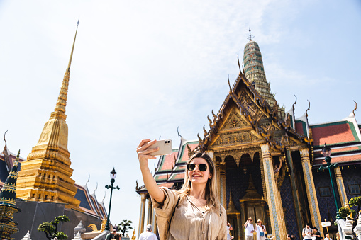 Young woman exploring Grand Palace and Wat Phra Kaew in Bangkok, Thailand