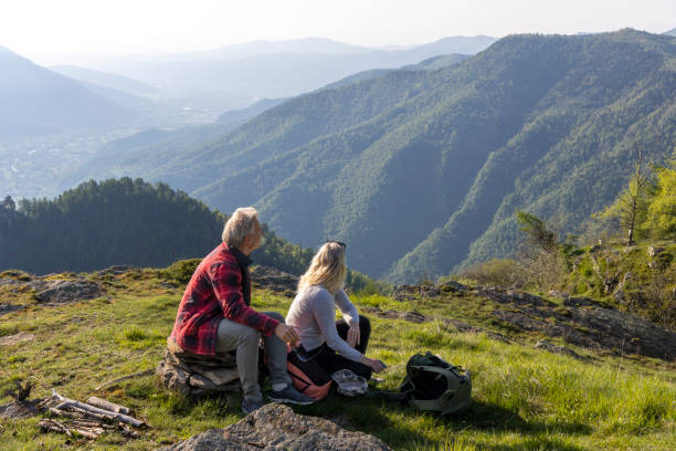 istock Mature couple explore mountain meadow in morning light 1494790534