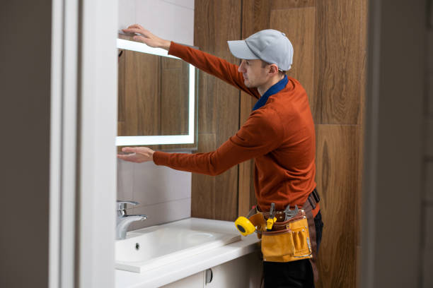 istock The worker installs the mirror in the bathroom. 1494790552