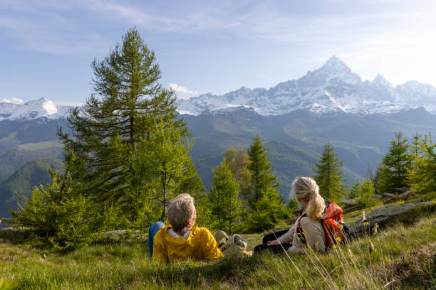 istock Mature couple explore mountain meadow in morning light 1494790724