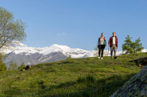istock Mature couple explore mountain meadow in morning light 1494791277