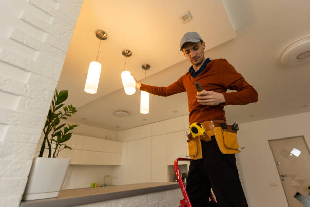istock Electrician man working on exterior light, install LED replacement lamp at home. Maintenance concept. 1494791626