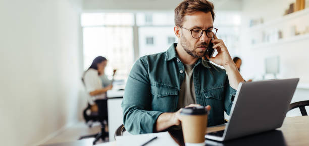 istock Male designer making a phone call to a client in an office 1494791778