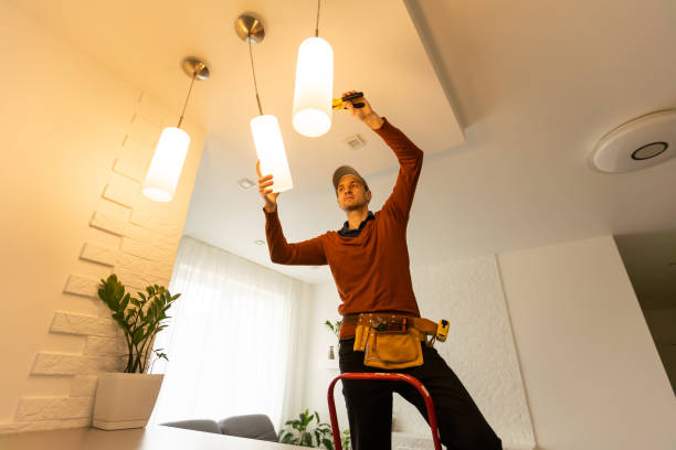 istock Electrician man working on exterior light, install LED replacement lamp at home. Maintenance concept. 1494791865