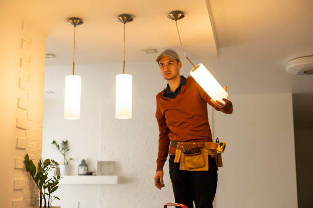 istock Electrician man working on exterior light, install LED replacement lamp at home. Maintenance concept. 1494793583