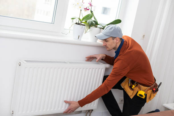 istock adjustment of heating radiator. temperature. 1494794090