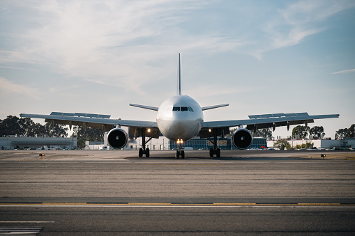 At dusk, a large cargo plane enters the runway, preparing to unload its cargo.