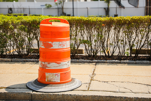 Orange construction cones represent construction zones, roadwork, caution, and temporary barriers for safety and traffic control