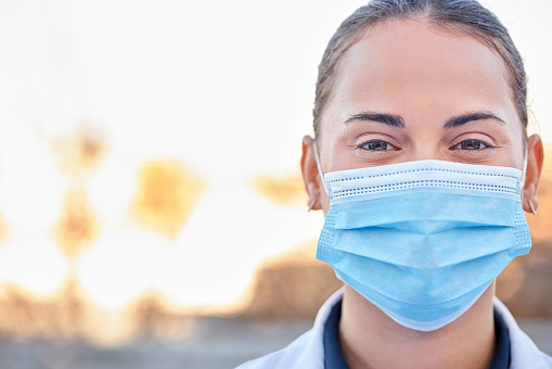 Covid mask, doctor and woman portrait outdoor for medical and health insurance. Face of a healthcare worker with ppe for safety policy, compliance and corona virus protection for wellness and help