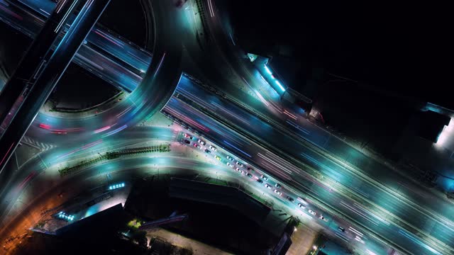 Hyperlapse time-lapse of car traffic transportation above circle roundabout road in Asian city.