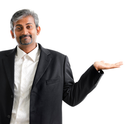 Mature Asian Indian businessman arm out showing empty space, isolated on white
