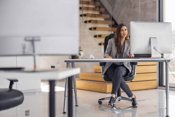 istock Female entrepreneur with computer working in modern office 1494809344