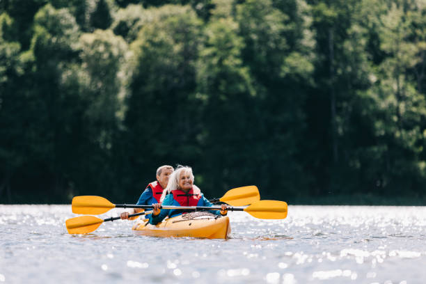 istock Happy senior active couple kayaking on lake 1494809631