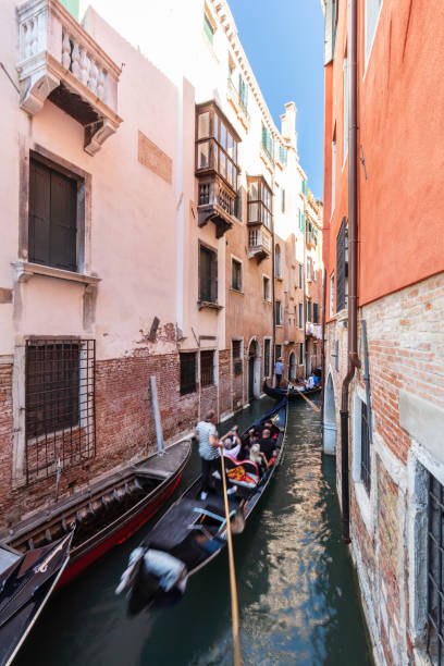 istock Gondolier rowing gondola on canal in Venice, Italy. 1494809718