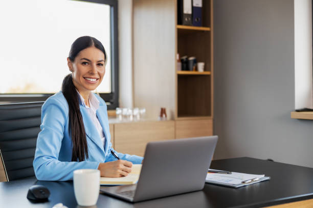 istock Confident businesswoman working on laptop at her workplace at modern office 1494810536