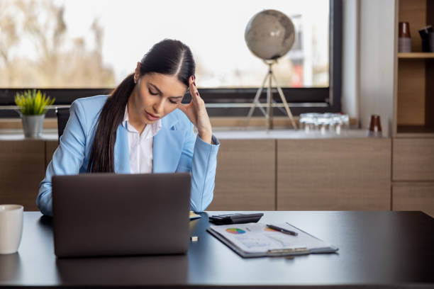istock Exhausted businesswoman having a headache in her office 1494811255