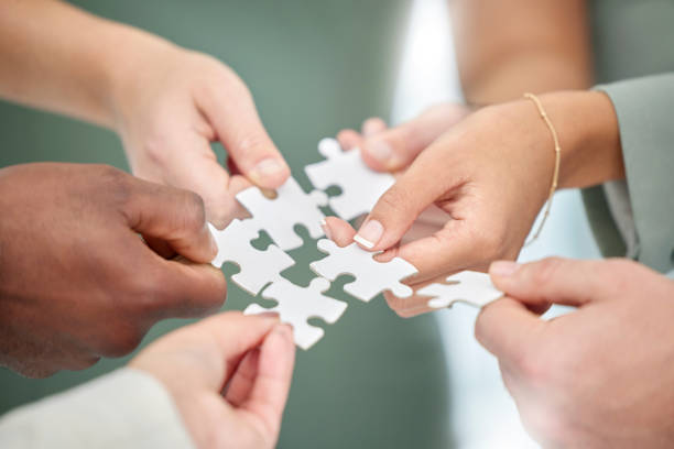 istock Business people, hands and diversity with puzzle piece for team building, collaboration or planning in unity. Hand of group teamwork, brainstorming or strategy for engagement, support or interaction 1494815255
