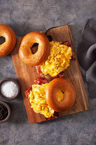 breakfast egg and bacon sandwich on bagel with cheese