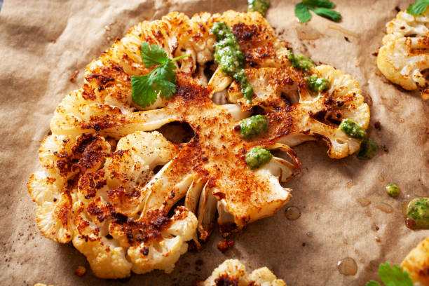 istock cauliflower steaks with herb and spice on baking tray. plant based meat substitute 1494815374