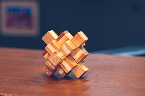 Wooden interlocking cube on blurry background using as creation concept