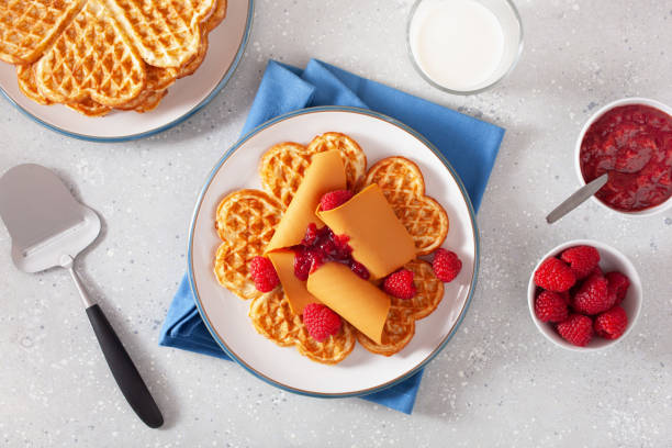istock waffles with Norwegian brunost traditional brown cheese and raspberry jam 1494816334
