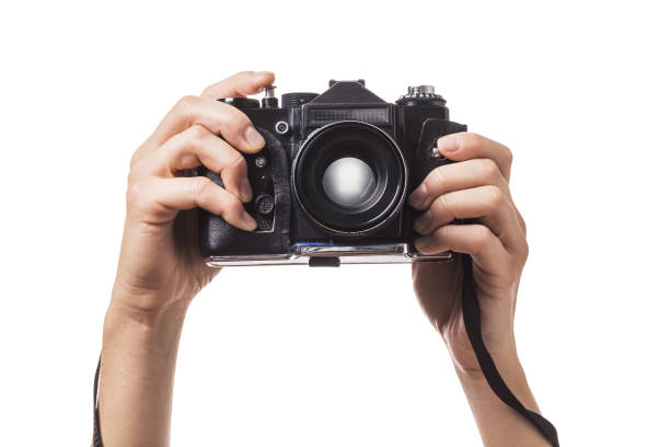 Camera in hands isolated on white background stock photo