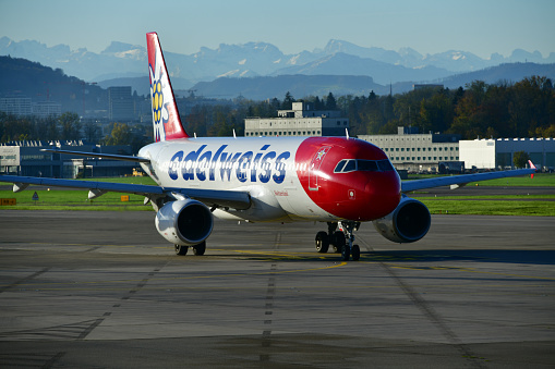 Zurich / Kloten, Switzerland: Edelweiss Air Airbus A320-214 (HB-IHZ, MSN 1026), taxiing at Zurich Airport (ZRH) with the Swiss Alps in the background - Edelweiss Air is a Swiss leisure and charter airline headquartered in Kloten and based at Zurich Airport . Edelweiss Air is a subsidiary of Lufthansa and thus a sister company of Swiss International Air Lines.