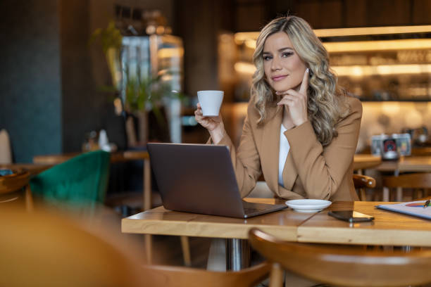 istock Businesswoman working on laptop and drinking coffee 1494816933